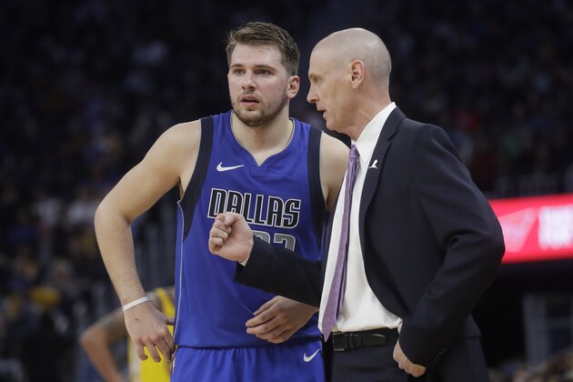 Dallas Mavericks forward Luka Doncic, left, talks with head coach Rick Carlisle during an NBA basketball game against the Golden State Warriors in San Francisco, Saturday, Dec. 28, 2019. (AP Photo/Jeff Chiu)