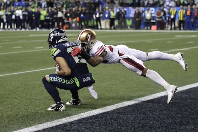 Seattle Seahawks' John Ursua, left, makes a catch at the one-yard line to give the team a first down with less than a minute left as San Francisco 49ers' K'Waun Williams tackles during the second half of an NFL football game, Sunday, Dec. 29, 2019, in Seattle. The 49ers won 26-21. (AP Photo/Stephen Brashear)