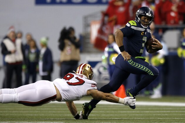 SEATTLE, WASHINGTON - DECEMBER 29: Defensive end Nick Bosa #97 of the San Francisco 49ers dives to tackle quarterback Russell Wilson #3 of the Seattle Seahawks during the game at CenturyLink Field on December 29, 2019 in Seattle, Washington. (Photo by Otto Greule Jr/Getty Images)