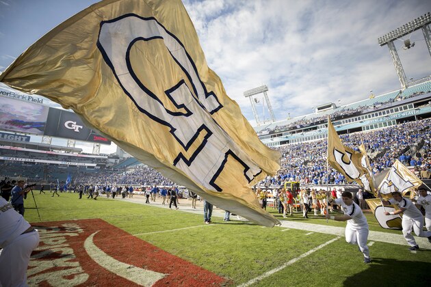 Georgia Tech cheerleaders run onto EverBank Field before the start of the TaxSlayer Bowl NCAA college football game against Kentucky, Saturday, Dec. 31, 2016, in Jacksonville, Fla. (AP Photo/Stephen B. Morton)
