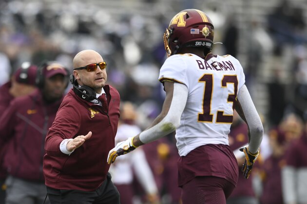 Minnesota head coach P.J. Fleck left, celebrates with wide receiver Rashod Bateman (13) after Bateman caught a touchdown pass during the first half of an NCAA football game against Northwestern, Saturday, Nov. 23, 2019, in Evanston, Ill. (AP Photo/Paul Beaty)