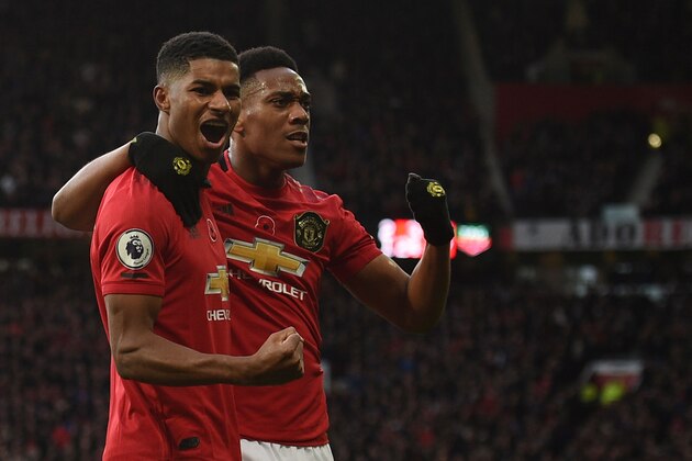 Manchester United's English striker Marcus Rashford (L) celebrates scoring their third goal with Manchester United's French striker Anthony Martial (R) during the English Premier League football match between Manchester United and Brighton and Hove Albion at Old Trafford in Manchester, north west England, on November 10, 2019. (Photo by Oli SCARFF / AFP) / RESTRICTED TO EDITORIAL USE. No use with unauthorized audio, video, data, fixture lists, club/league logos or 'live' services. Online in-match use limited to 120 images. An additional 40 images may be used in extra time. No video emulation. Social media in-match use limited to 120 images. An additional 40 images may be used in extra time. No use in betting publications, games or single club/league/player publications. /  (Photo by OLI SCARFF/AFP via Getty Images)