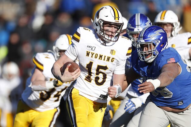 Wyoming quarterback Levi Williams, left, is tackled by Air Force defensive lineman Mosese Fifita after a short gain in the second half of an NCAA college football game Saturday, Nov. 30, 2019, at Air Force Academy, Colo. Air Force won 20-6. (AP Photo/David Zalubowski)