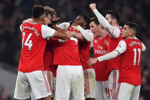 Arsenal's Greek defender Sokratis Papastathopoulos celebrates with teammates after scoring their second goal during the English Premier League football match between Arsenal and Manchester United at the Emirates Stadium in London on January 1, 2020. (Photo by Ben STANSALL / AFP) / RESTRICTED TO EDITORIAL USE. No use with unauthorized audio, video, data, fixture lists, club/league logos or 'live' services. Online in-match use limited to 120 images. An additional 40 images may be used in extra time. No video emulation. Social media in-match use limited to 120 images. An additional 40 images may be used in extra time. No use in betting publications, games or single club/league/player publications. / (Photo by BEN STANSALL/AFP via Getty Images) Arsenal's Greek defender Sokratis Papastathopoulos celebrates with teammates after scoring their second goal during the English Premier League football match between Arsenal and Manchester United at the Emirates Stadium in London on January 1, 2020. (Photo by Ben STANSALL / AFP) / RESTRICTED TO EDITORIAL USE. No use with unauthorized audio, video, data, fixture lists, club/league logos or 'live' services. Online in-match use limited to 120 images. An additional 40 images may be used in extra time. No video emulation. Social media in-match use limited to 120 images. An additional 40 images may be used in extra time. No use in betting publications, games or single club/league/player publications. / (Photo by BEN STANSALL/AFP via Getty Images)