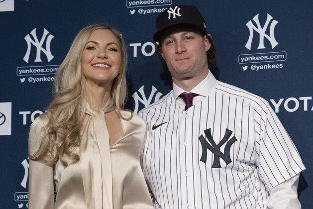 Gerrit Cole and his wife Amy pose for photos as he is introduced as the newest New York Yankees player during a baseball media availability, Wednesday, Dec. 18, 2019 in New York. The pitcher agreed to a 9-year $324 million contract. (AP Photo/Mark Lennihan)