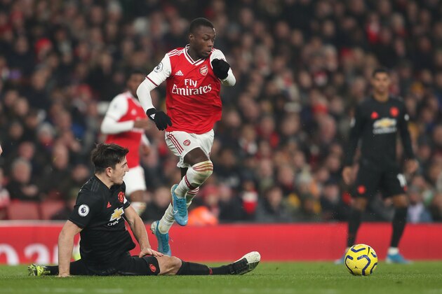 LONDON, ENGLAND - JANUARY 01: Harry Maguire of Manchester United and Nicolas Pepe of Arsenal during the Premier League match between Arsenal FC and Manchester United at Emirates Stadium on January 1, 2020 in London, United Kingdom. (Photo by James Williamson - AMA/Getty Images)
