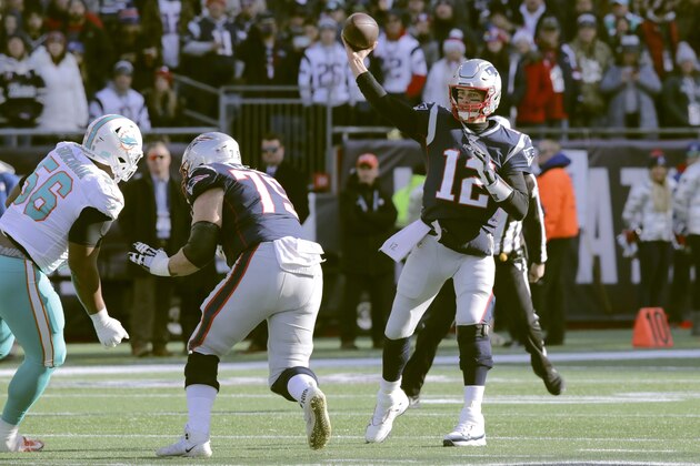 New England Patriots quarterback Tom Brady passes under pressure from Miami Dolphins defensive tackle Davon Godchaux, left, in the first half of an NFL football game, Sunday, Dec. 29, 2019, in Foxborough, Mass. (AP Photo/Charles Krupa)
