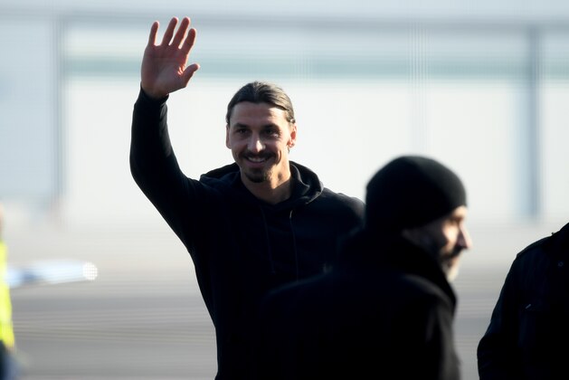 Newly appointed AC Milan forward Zlatan Ibrahimovic waves upon his arrival at  Linate airport, on January 2, 2020. - Ibrahimovic has signed with AC Milan on a six-month deal, promising to help rescue the struggling Serie A outfit's season. The 38-year-old will undergo his medical on  January 2 and will hold his first press conference the following day. (Photo by STR / AFP) (Photo by STR/AFP via Getty Images)