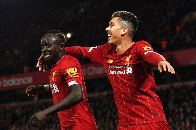 Liverpool's Senegalese striker Sadio Mane (L) celebrates with Liverpool's Brazilian midfielder Roberto Firmino after he scores his team's second goal during the English Premier League football match between Liverpool and Sheffield United at Anfield in Liverpool, north west England on January 2, 2020. (Photo by Paul ELLIS / AFP) / RESTRICTED TO EDITORIAL USE. No use with unauthorized audio, video, data, fixture lists, club/league logos or 'live' services. Online in-match use limited to 120 images. An additional 40 images may be used in extra time. No video emulation. Social media in-match use limited to 120 images. An additional 40 images may be used in extra time. No use in betting publications, games or single club/league/player publications. /  (Photo by PAUL ELLIS/AFP via Getty Images)