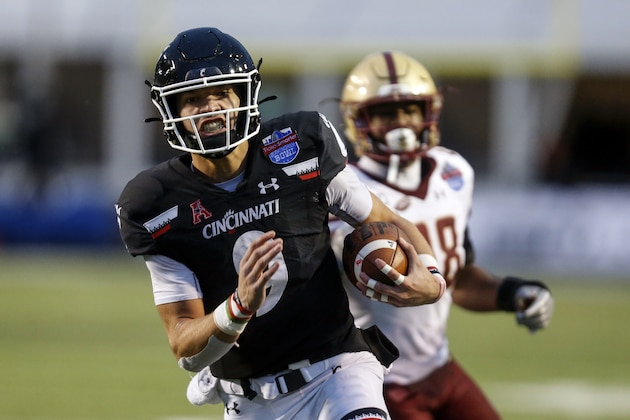 Cincinnati quarterback Desmond Ridder (9) carries the ball for a touchdown against Boston College during the first half of the Birmingham Bowl NCAA college football game Thursday, Jan. 2, 2020, in Birmingham, Ala. (AP Photo/Butch Dill)