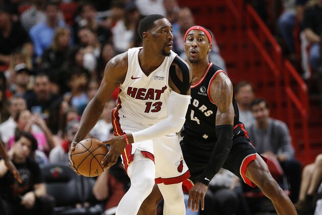 MIAMI, FLORIDA - JANUARY 02:  Bam Adebayo #13 of the Miami Heat is defended by Rondae Hollis-Jefferson #4 of the Toronto Raptors during the first half at American Airlines Arena on January 02, 2020 in Miami, Florida. NOTE TO USER: User expressly acknowledges and agrees that, by downloading and/or using this photograph, user is consenting to the terms and conditions of the Getty Images License Agreement. (Photo by Michael Reaves/Getty Images)
