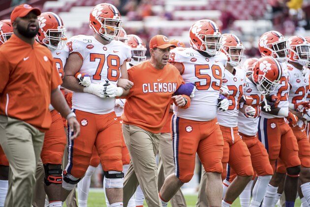 Clemson head coach Dabo Swinney, lineman Chandler Reeves (78) and Gage Cervenka (59) walk across the field before an NCAA college football game against South Carolina Saturday, Nov. 30, 2019, in Columbia, S.C. Clemson defeated South Carolina 38-3. (AP Photo/Sean Rayford)