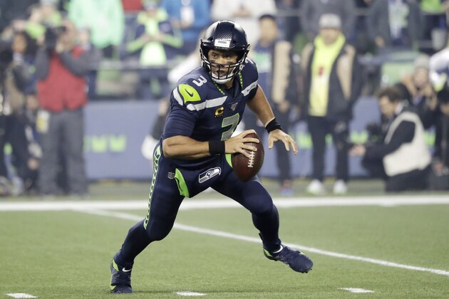 Seattle Seahawks quarterback Russell Wilson looks for room to pass against the San Francisco 49ers during the first half of an NFL football game, Sunday, Dec. 29, 2019, in Seattle. (AP Photo/Ted S. Warren)