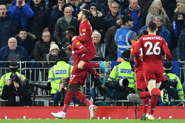Liverpool's Belgium striker Divock Origi (L) celebrates scoring the opening goal during the English Premier League football match between Liverpool and Everton at Anfield in Liverpool, north west England on December 4, 2019. (Photo by Paul ELLIS / AFP) / RESTRICTED TO EDITORIAL USE. No use with unauthorized audio, video, data, fixture lists, club/league logos or 'live' services. Online in-match use limited to 120 images. An additional 40 images may be used in extra time. No video emulation. Social media in-match use limited to 120 images. An additional 40 images may be used in extra time. No use in betting publications, games or single club/league/player publications. /  (Photo by PAUL ELLIS/AFP via Getty Images)