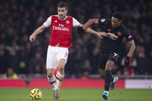 LONDON, ENGLAND - JANUARY 01: Sokratis Papastathopoulos of Arsenal and Anthony Martial of Manchester United during the Premier League match between Arsenal FC and Manchester United at Emirates Stadium on January 01, 2020 in London, United Kingdom. (Photo by Visionhaus)