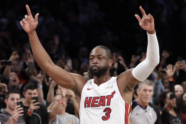 Miami Heat guard Dwyane Wade (3) acknowledges the crowd's cheers after playing in the final NBA basketball game of his career, against the Brooklyn Nets on Wednesday, April 10, 2019, in New York. (AP Photo/Kathy Willens)