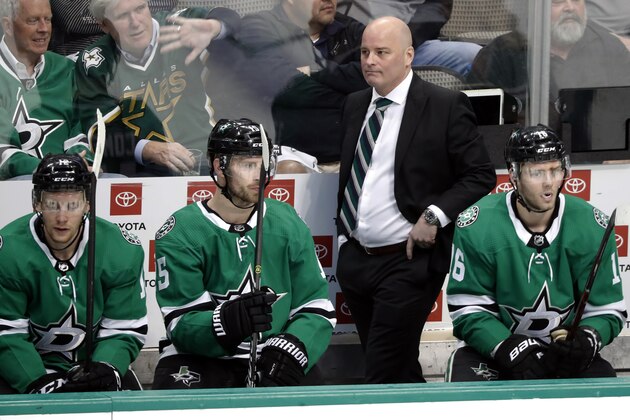 Dallas Stars' Radek Faksa (12), Blake Comeau (15) head coach Jim Montgomery, rear, and Jason Dickinson (16) watch play against the Nashville Predators in Game 3 in an NHL hockey first-round playoff series in Dallas, Monday, April 15, 2019. (AP Photo/Tony Gutierrez)