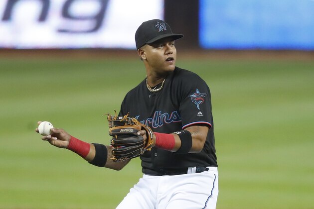 Miami Marlins third baseman Starlin Castro prepares to throw to first to put out Washington Nationals' Adam Eaton during the first inning of a baseball game Friday, Sept. 20, 2019, in Miami. (AP Photo/Wilfredo Lee)