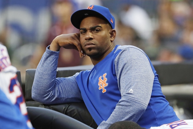 FILE - In this July 24, 2018, file photo, New York Mets' Yoenis Cespedes looks on as his team play the San Diego Padres during the first inning of a baseball game in New York. Cespedes' salary for 2019 was cut in half and his pay for 2020 reduced as part of a settlement of a grievance between the injured outfielder and the Mets. He agreed to a $110 million, four-year contract in December 2016 but has not played since July 20, 2018. The outfielder had surgery to remove bone calcification from his right heel on Aug. 2, 2018, and his left that Oct. 26. (AP Photo/Frank Franklin II, File) FILE - In this July 24, 2018, file photo, New York Mets' Yoenis Cespedes looks on as his team play the San Diego Padres during the first inning of a baseball game in New York. Cespedes' salary for 2019 was cut in half and his pay for 2020 reduced as part of a settlement of a grievance between the injured outfielder and the Mets. He agreed to a $110 million, four-year contract in December 2016 but has not played since July 20, 2018. The outfielder had surgery to remove bone calcification from his right heel on Aug. 2, 2018, and his left that Oct. 26. (AP Photo/Frank Franklin II, File)