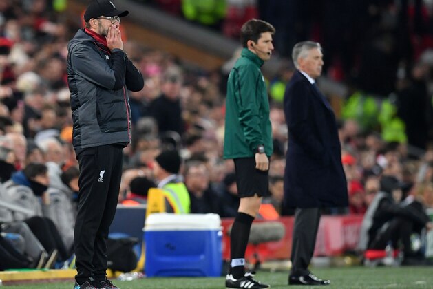 Liverpool's German manager Jurgen Klopp (L) and Napoli's Italian head coach Carlo Ancelotti (R) watches his players from the touchline during the UEFA Champions league Group E football match between Liverpool and Napoli at Anfield in Liverpool, north west England on November 27, 2019. (Photo by Paul ELLIS / AFP) (Photo by PAUL ELLIS/AFP via Getty Images)