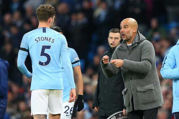 MANCHESTER, ENGLAND - APRIL 03: Pep Guardiola the manager of Manchester City talks with John Stones during the Premier League match between Manchester City and Cardiff City at Etihad Stadium on April 03, 2019 in Manchester, United Kingdom. (Photo by Alex Livesey - Danehouse/Getty Images)