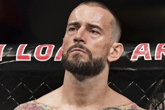 FILE - In this Sept. 10, 2016, file photo, CM Punk stands in his corner before a welterweight bout at UFC 203 in Cleveland. Punk went 0-2 in UFC and has given himself until the new year to decide if he wants to keep fighting. Punk hopes to stick in the sport as a mixed martial arts announcer. (AP Photo/David Dermer, File)