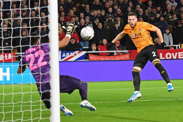 Wolverhampton Wanderers' Irish defender Matt Doherty (R) sees his shot saved by Manchester United's Argentinian goalkeeper Sergio Romero (L) during the FA Cup third round football match between Wolverhampton Wanderers and Manchester United at the Molineux stadium in Wolverhampton, central England on January 4, 2020. (Photo by Justin TALLIS / AFP) / RESTRICTED TO EDITORIAL USE. No use with unauthorized audio, video, data, fixture lists, club/league logos or 'live' services. Online in-match use limited to 120 images. An additional 40 images may be used in extra time. No video emulation. Social media in-match use limited to 120 images. An additional 40 images may be used in extra time. No use in betting publications, games or single club/league/player publications. /  (Photo by JUSTIN TALLIS/AFP via Getty Images)