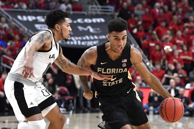 Florida State guard Anthony Polite (2) attempts to get away from the defense of Louisville guard Lamarr Kimble (0) during the first half of an NCAA college basketball game in Louisville, Ky., Saturday, Jan. 4, 2020. (AP Photo/Timothy D. Easley)