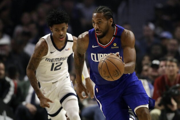 Los Angeles Clippers' Kawhi Leonard, right, dribbles past Memphis Grizzlies' Ja Morant (12) during the first half of an NBA basketball game Saturday, Jan. 4, 2020, in Los Angeles. (AP Photo/Marcio Jose Sanchez)