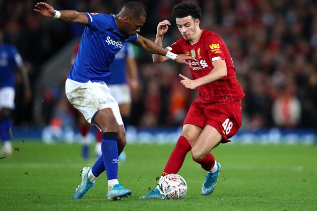 LIVERPOOL, ENGLAND - JANUARY 05: Curtis Jones of Liverpool battles for possession with Djibril Sidibe of Everton during the FA Cup Third Round match between Liverpool and Everton at Anfield on January 05, 2020 in Liverpool, England. (Photo by Clive Brunskill/Getty Images)