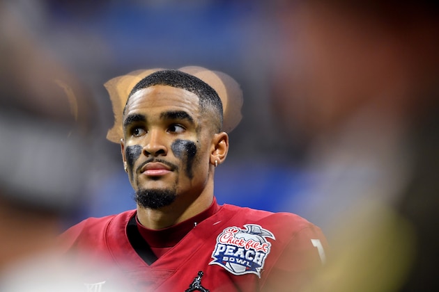 Oklahoma quarterback Jalen Hurts (1) stands on the bench against LSU during the second half of the Peach Bowl NCAA semifinal college football playoff game, Saturday, Dec. 28, 2019, in Atlanta. (AP Photo/John Amis)
