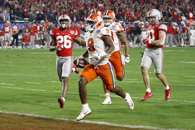 Clemson running back Travis Etienne scores a touchdown against Ohio State during the second half of the Fiesta Bowl NCAA college football playoff semifinal Saturday, Dec. 28, 2019, in Glendale, Ariz. (AP Photo/Ross D. Franklin)