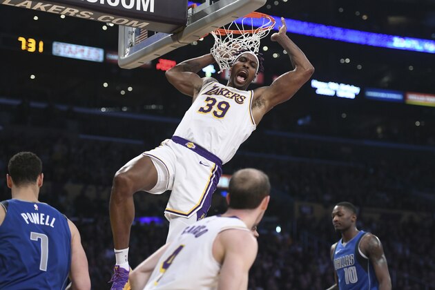Los Angeles Lakers center Dwight Howard dunks against the Dallas Mavericks during an NBA basketball game Sunday, Dec. 29, 2019, in Los Angeles. (AP Photo/Michael Owen Baker)