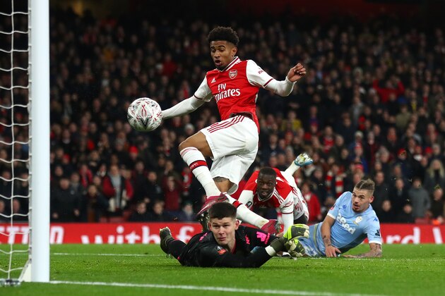 LONDON, ENGLAND - JANUARY 06:  Reiss Nelson of Arsenal scores his side's first goal past Illan Meslier of Leeds United during the FA Cup Third Round match between Arsenal FC and Leeds United at the Emirates Stadium on January 06, 2020 in London, England. (Photo by Julian Finney/Getty Images)