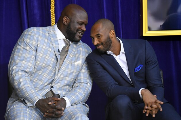 FILE - In this March 24, 2017, file photo, Shaquille O'Neal, left, and Kobe Bryant chat at the unveiling of a statue of O'Neal in front of the Staples Center in Los Angeles. Bryant downplayed talk of a reignited feud with Shaquille O'Neal, saying there is