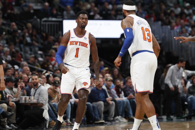 New York Knicks forward Bobby Portis, left, celebrates with forward Marcus Morris Sr. after hitting a basket in the second half of an NBA basketball game against the the Denver Nuggets, Sunday, Dec. 15, 2019, in Denver.  (AP Photo/David Zalubowski)
