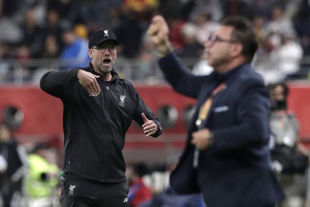 In this Dec. 18, 2019 photo, Liverpool's manager Jurgen Klopp, left, argues with Monterrey's head coach Antonio Mohamed during the Club World Cup semifinal soccer match between Liverpool and Monterrey at the Khalifa International Stadium in Doha, Qatar. Liverpool won 2-1. (AP Photo/Hassan Ammar)