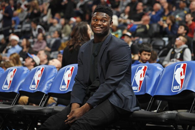 Injured New Orleans Pelicans forward Zion Williamson smiles as he jokes with fans while waiting on the team bench for the second half of the team's NBA basketball game against the Denver Nuggets on Wednesday, Dec. 25, 2019, in Denver. The Pelicans won 112-100. (AP Photo/David Zalubowski) Injured New Orleans Pelicans forward Zion Williamson smiles as he jokes with fans while waiting on the team bench for the second half of the team's NBA basketball game against the Denver Nuggets on Wednesday, Dec. 25, 2019, in Denver. The Pelicans won 112-100. (AP Photo/David Zalubowski)