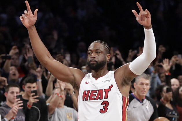 Miami Heat guard Dwyane Wade (3) acknowledges the crowd's cheers after playing in the final NBA basketball game of his career, against the Brooklyn Nets, Wednesday, April 10, 2019, in New York. (AP Photo/Kathy Willens)