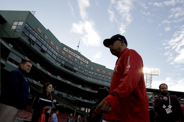 Boston Red Sox manager Alex Cora walks to the dugout after batting practice before Game 2 of a baseball American League Championship Series against the Houston Astros on Sunday, Oct. 14, 2018, in Boston. (AP Photo/Charles Krupa)