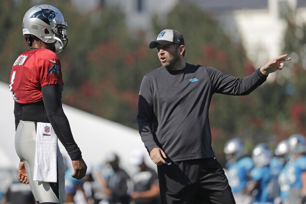 Carolina Panthers quarterbacks coach Scott Turner, right, talks with Cam Newton (1) during practice at the NFL football team's training camp in Spartanburg, S.C., Monday, July 29, 2019. (AP Photo/Chuck Burton)