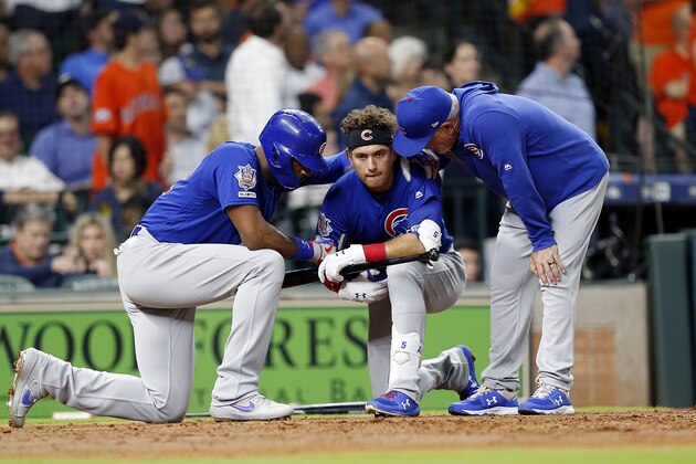 HOUSTON, TEXAS - MAY 29: Albert Almora Jr. #5 of the Chicago Cubs is comforted by manager Joe Maddon #70 and Jason Heyward #22 after a young child was injured on foul ball off his bat in the fourth inning against the Houston Astros at Minute Maid Park on May 29, 2019 in Houston, Texas. (Photo by Bob Levey/Getty Images)