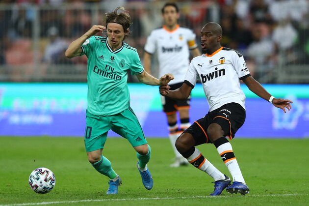 JEDDAH, SAUDI ARABIA - JANUARY 08: Luka Modric of Real Madrid holds off Geoffrey Kondogbia of Valencia during the Supercopa de Espana Semi-Final match between Valencia CF and Real Madrid at King Abdullah Sports City on January 08, 2020 in Jeddah, Saudi Arabia. (Photo by Francois Nel/Getty Images)