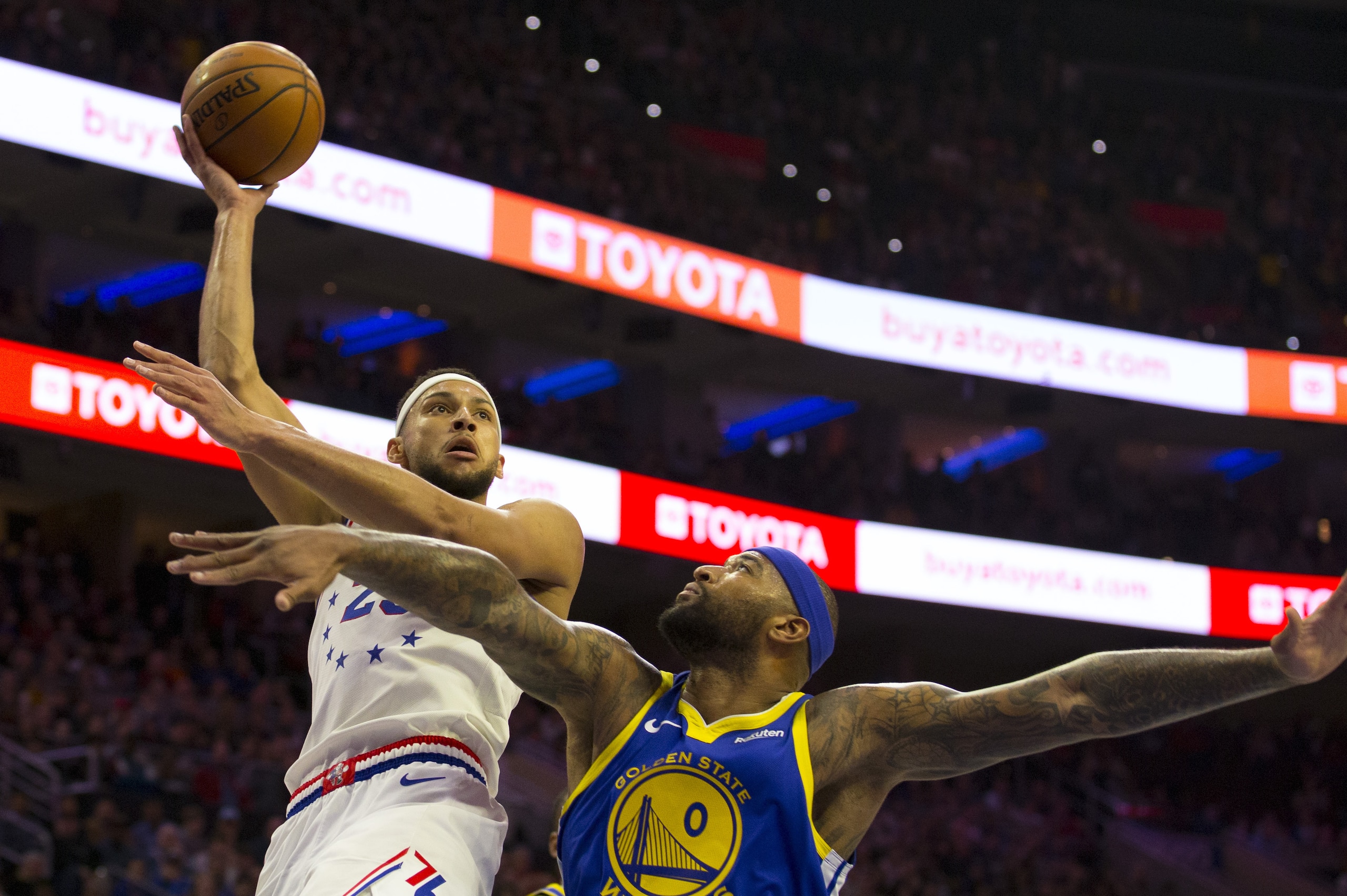 PHILADELPHIA, PA - MARCH 02: Ben Simmons #25 of the Philadelphia 76ers shoots the ball against DeMarcus Cousins #0 of the Golden State Warriors at the Wells Fargo Center on March 2, 2019 in Philadelphia, Pennsylvania. The Warriors defeated the 76ers 120-117. NOTE TO USER: User expressly acknowledges and agrees that, by downloading and or using this photograph, User is consenting to the terms and conditions of the Getty Images License Agreement. (Photo by Mitchell Leff/Getty Images)