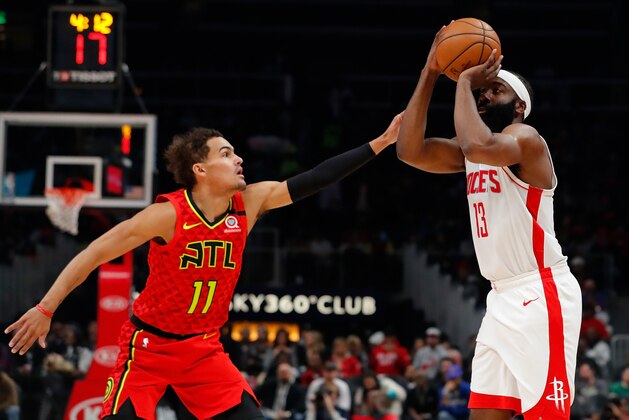 ATLANTA, GEORGIA - JANUARY 08:  James Harden #13 of the Houston Rockets shoots a three-point basket against Trae Young #11 of the Atlanta Hawks in the first half at State Farm Arena on January 08, 2020 in Atlanta, Georgia.  NOTE TO USER: User expressly acknowledges and agrees that, by downloading and/or using this photograph, user is consenting to the terms and conditions of the Getty Images License Agreement.  (Photo by Kevin C. Cox/Getty Images)