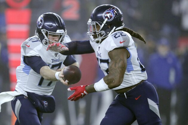 Tennessee Titans quarterback Ryan Tannehill, left, hands off to running back Derrick Henry in the first half of an NFL wild-card playoff football game against the New England Patriots, Saturday, Jan. 4, 2020, in Foxborough, Mass. (AP Photo/Charles Krupa)
