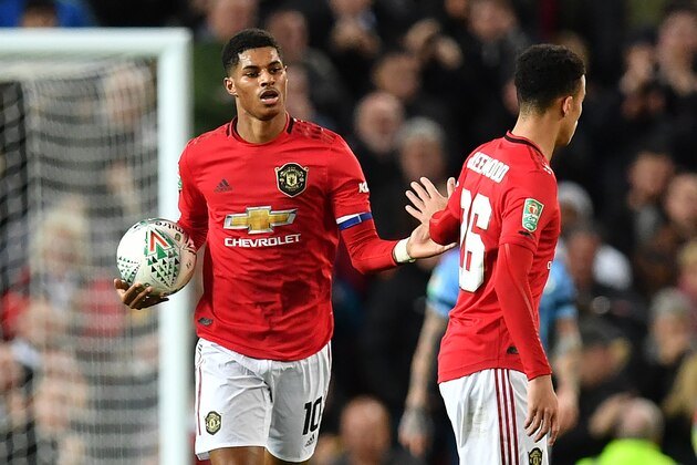 Manchester United's English striker Marcus Rashford celebrates scoring his team's first goal with Manchester United's English striker Mason Greenwood during the English League Cup semi-final first leg football match between Manchester United and Manchester City at Old Trafford in Manchester, north west England on January 7, 2020. (Photo by Paul ELLIS / AFP) / RESTRICTED TO EDITORIAL USE. No use with unauthorized audio, video, data, fixture lists, club/league logos or 'live' services. Online in-match use limited to 75 images, no video emulation. No use in betting, games or single club/league/player publications. /  (Photo by PAUL ELLIS/AFP via Getty Images)