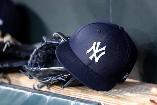 BALTIMORE, MARYLAND - APRIL 06: A New York Yankees hat and glove sit in the dugout before the start of the Yankees and Baltimore Orioles game  at Oriole Park at Camden Yards on April 06, 2019 in Baltimore, Maryland. (Photo by Rob Carr/Getty Images)