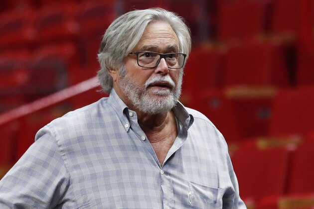 In this March 13, 2019 photo, Micky Arison, Miami Heat managing general partner and chairman of Carnival Cruise Line, walks courtside before the start of an NBA basketball game in Miami. A federal judge has threatened to temporarily block Carnival Corp. from docking cruise ships at ports in the United States as punishment for a possible probation violation. The Miami Herald reports U.S. District Judge Patricia Seitz said Wednesday, April 10, 2019 that she’ll make a decision in June, and she wants company chairman Micky Arison and president Donald Arnold to attend that hearing.  (AP Photo/Wilfredo Lee)