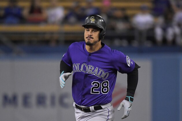 Colorado Rockies' Nolan Arenado heads to third after hitting a solo home run as Los Angeles Dodgers catcher Will Smith watches during the first inning of a baseball game Friday, Sept. 20, 2019, in Los Angeles. (AP Photo/Mark J. Terrill)